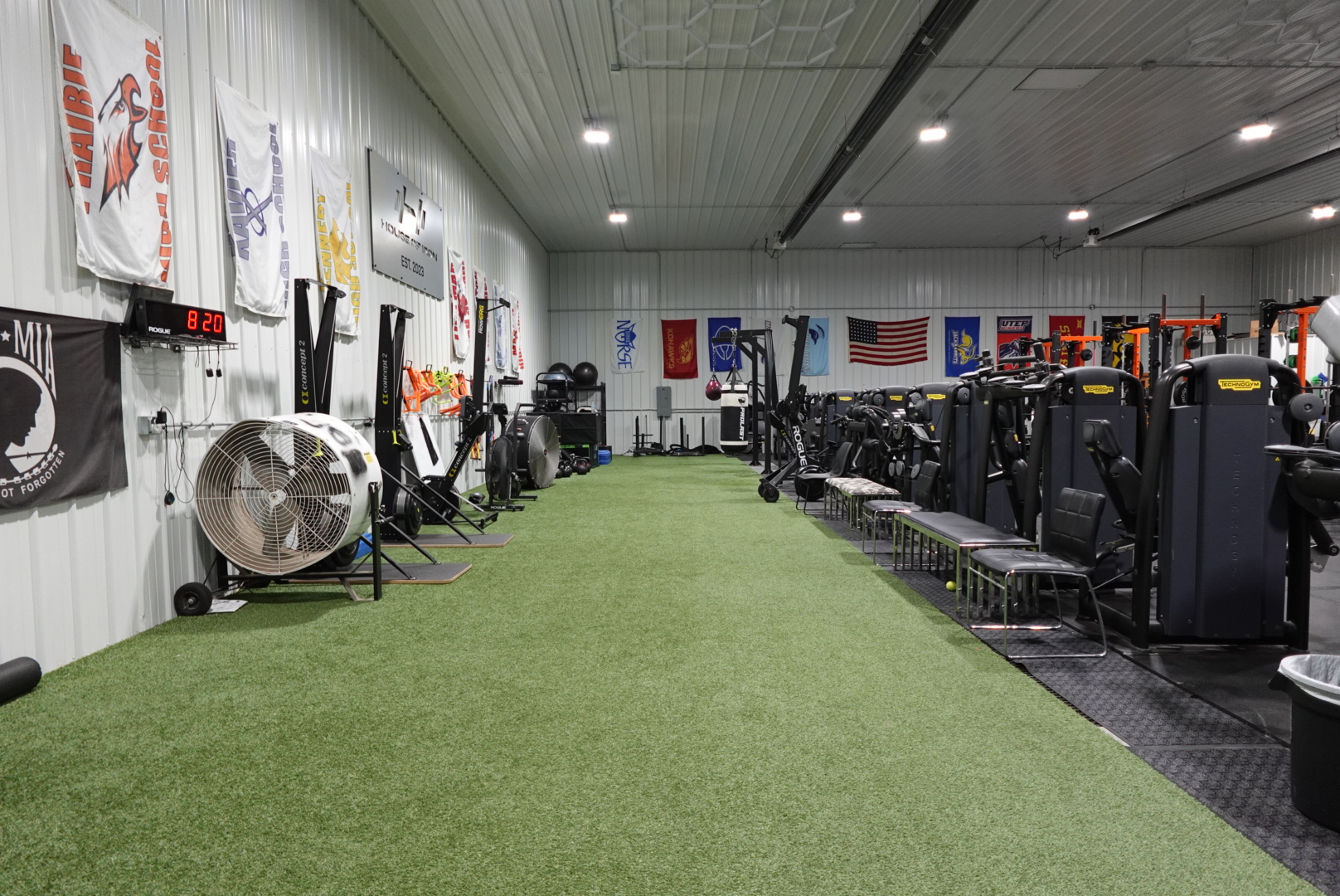 Iron and bumper plates stored on a rack at House of Iron Westside