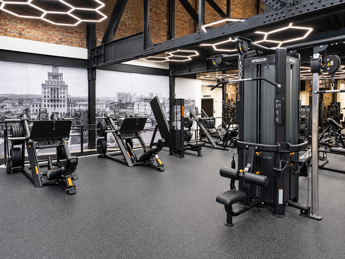 Dumbbells and an adjustable bench inside the Downtown training room